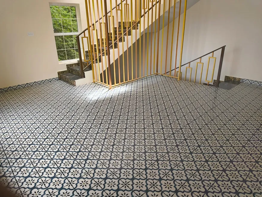 Finished stairwell with patterned flooring and metal railing