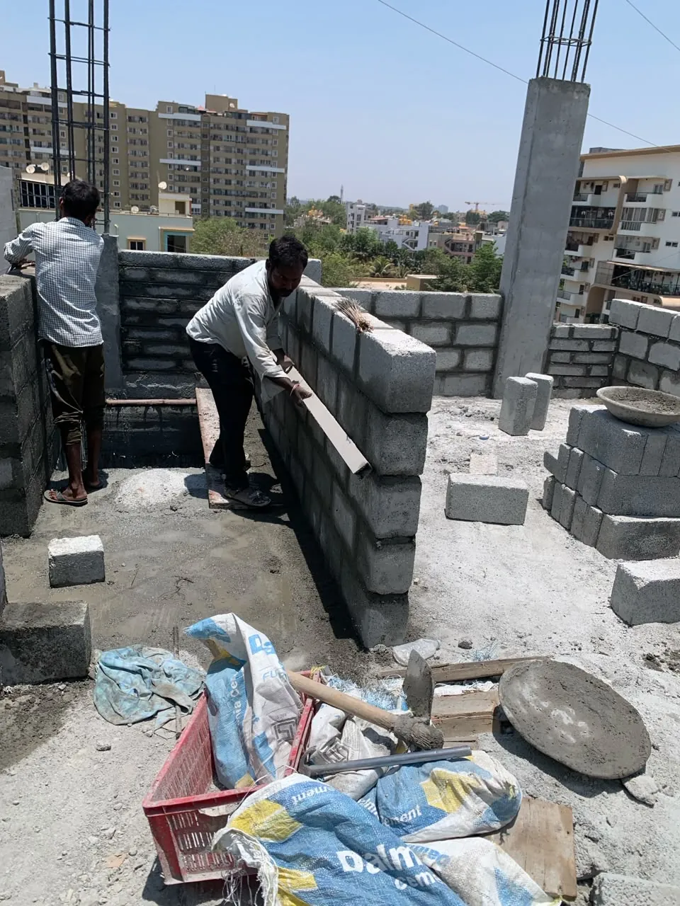 Masons laying blockwork on an upper floor